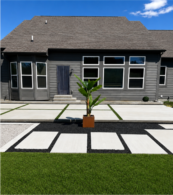 Modern decorative concrete driveway with turf channels